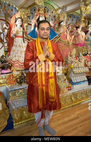 Posed portrait of a Hindu priest - or Brahmin or pundit  - at the Shri Lakshmi Narayan Mandir  temple in Richmond Hill, Queens, New York. Stock Photo