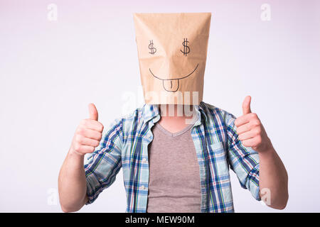 Man with cardboard box on his head with picture of dollar symbol instead of eyes. Stock Photo