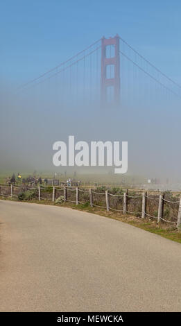 View of the Golden Gate Bridge, slowly visible as the fog started to clear up, from Crissy Field in San Francisco, California, United States. Stock Photo