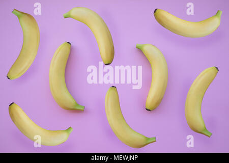 Fresh yellow bananas on pink background Stock Photo