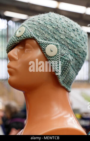 Knitted 1920's style ladies hat with decorative buttons at Yarndale, Skipton, North Yorkshire, UK. Stock Photo