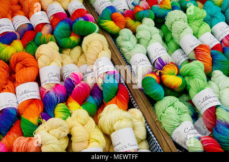 Multi-coloured skeins of wool on a retailers stall at Yarndale, Skipton, North Yorkshire, UK. Stock Photo