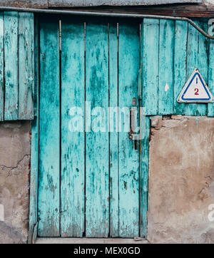 The Old turquoise Door with Cracked Paint Background Stock Photo