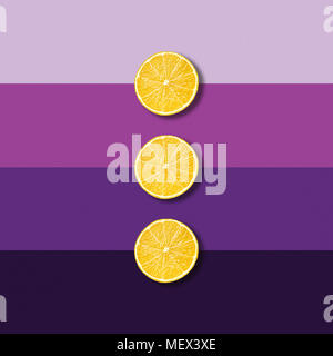 Three lemon fruit slices on electric purple background, abstract pop art picture Stock Photo