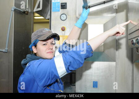 Female mechanical engineer working on machinery Stock Photo