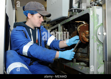 Female mechanical engineer working on machinery Stock Photo