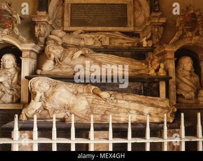 The tomb of Sir Roger Smith Knight at Edmondthorpe church, Melton Mowbray, Leicestershire, England Alabaster effigies of Sir Roger and his two wives, Jane nee Heron (d.1599) and Anne nee Goodman (d.1652) below him. His son Edward (d.1632 aged 34) and grandson Roger (d.1646 aged 19) are shown either side. The effigy of Lady Ann Smith, has a red stain on the wrist. She was considered to be a witch who could turn herself into a cat. Stock Photo