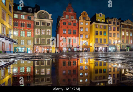 Colorful houses at famous Stortorget town square in Stockholm's historic Gamla Stan (Old Town) reflecting in a puddle at night, Stockholm, Sweden Stock Photo