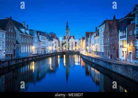 Beautiful panoramic view of famous Spiegelrei canal with famous Poortersloge and Jan van Eyck square in the background at dusk, Brugge, Belgium Stock Photo