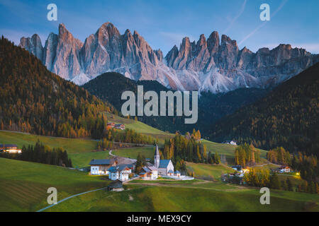 Beautiful view of idyllic mountain scenery in the Dolomites with famous Santa Maddelana mountain village in beautiful golden evening light at sunset Stock Photo