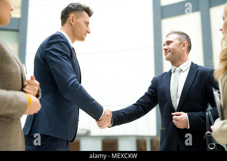 Business representatives shaking hands Stock Photo