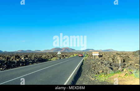 Scenic road and volcanic landscape in Timanfaya National Park. Lanzarote, Canary Islands. Spain Stock Photo