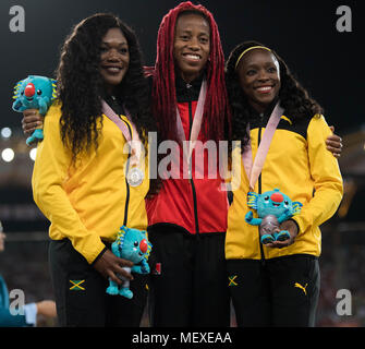 GOLD COAST, AUSTRALIA - APRIL 10: (L-R) Silver medalist Christania Williams of Jamaica, gold medalist Michelle-Lee Ahye of Trinidad and Tobago and bro Stock Photo