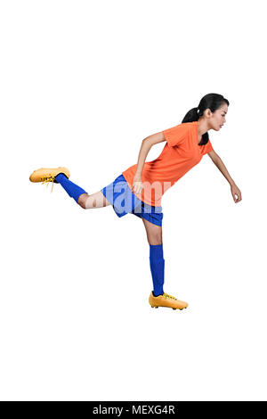 Professional asian football player woman kick the ball posing isolated over white background Stock Photo