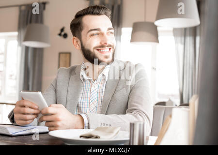 Happy dreamy businessman resting in restaurant Stock Photo