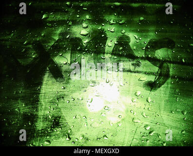 Big hand drawn scary letters XMAS on the car window, dark green background, horror mood, atmospheric christmas background Stock Photo