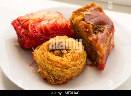 Three different kinds of baklava on the white plate