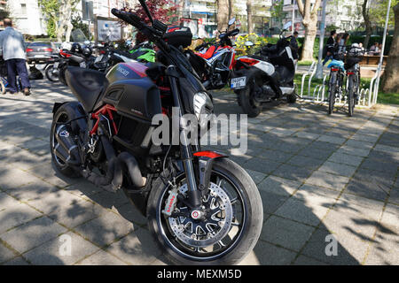 Istanbul, Turkey - April 22, 2018 : A Ducati Diavel Carbon and other motorcycles at Istanbul, Kadikoy Moda District. Some people are walking at the pa Stock Photo