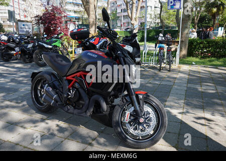 Istanbul, Turkey - April 22, 2018 : A Ducati Diavel Carbon and other motorcycles at Istanbul, Kadikoy Moda District. Some people are walking at the pa Stock Photo