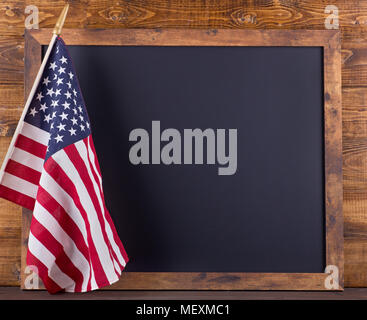 Blank chalkboard for copy space with American flag on a rustic wood background Stock Photo