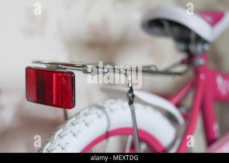 pink child's bicycle closeup with white wheels Stock Photo