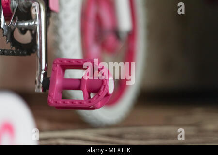 pink child's bicycle closeup with white wheels Stock Photo