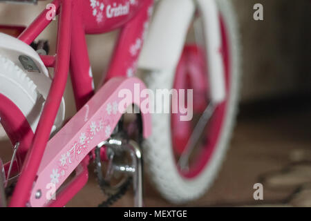 pink child's bicycle closeup with white wheels Stock Photo