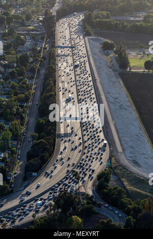 Vertical aerial view of afternoon traffic on the 12 lane Ventura Freeway passing the Sepulveda Basin in the San Fernando Valley area of Los Angeles, C Stock Photo