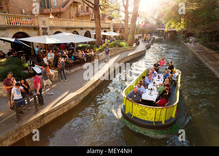 Travellers dine on a barge on the San Antonio river; San Antonio River Walk, San Antonio, Texas USA Stock Photo