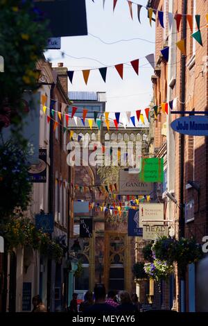 Gandy Street with Bunting in Exeter, Devon, UK. Narrow Cobbled Lane of Independent Shops. Supposedly the Inspiration for J.K. Rowling's  Diagon Alley. Stock Photo