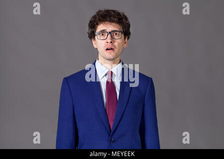 Emotional guy wearing in blue suit Stock Photo