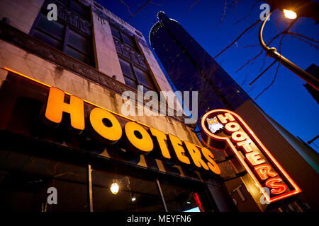 Atlanta capital of the U.S. state of Georgia, Exterior of Hooters bar neon sign outside their Downtown Peachtree restaurant at night Stock Photo