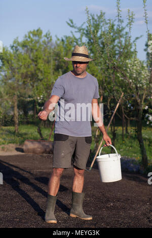 The gardener is laying out new grass. establishment of turf (Shallow DOF) Stock Photo