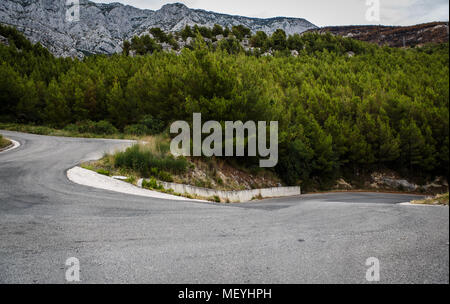 Mountain road in beautiful natural Biokovo Park in Croatia.High rocky mountains covered with green fir & pine trees forest Stock Photo