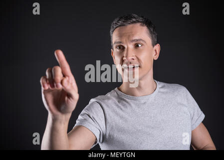 Smart handsome man using new technological device Stock Photo