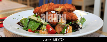 Breaded chicken salad, served in a restaurant setting Stock Photo