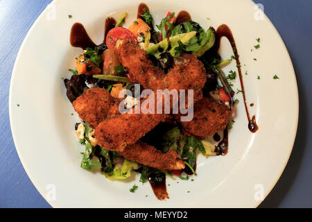 Breaded chicken salad, served in a restaurant setting Stock Photo