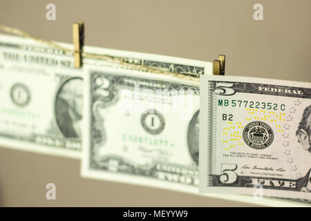 dollars are hanging on the clothesline clothespins attached Stock Photo