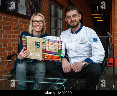 Tomasz Purol explains the structure of his cookbook to journalist Angela Berg. Chef Tomasz Purol in Hotel Blow up 5050, Posen Stock Photo