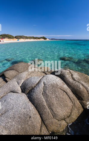 Rocks frame the turquoise water of sea around the sandy beach of Sant Elmo Castiadas Costa Rei Cagliari Sardinia Italy Europe Stock Photo