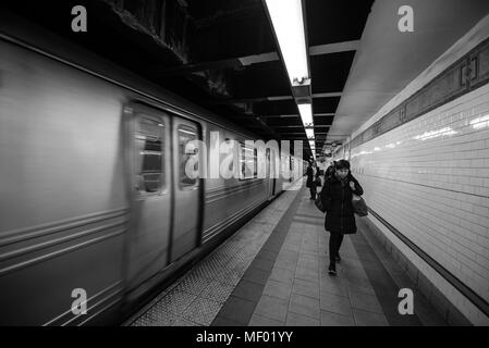 New York, NY, USA - December 22, 2016: Passengers walking briskly at New York Subway at Union Square. The NYC Subway is one of the most effective way Stock Photo