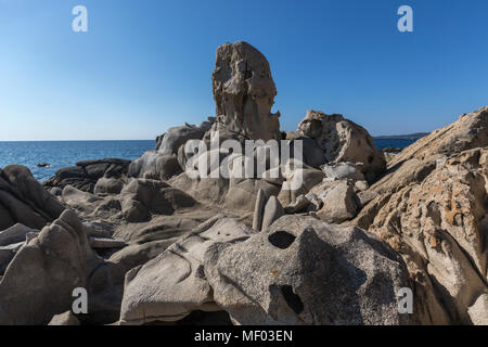 The sun shines on the rocks eroded by wind framing the blue sea Punta Molentis Villasimius Cagliari Sardinia Italy Europe Stock Photo