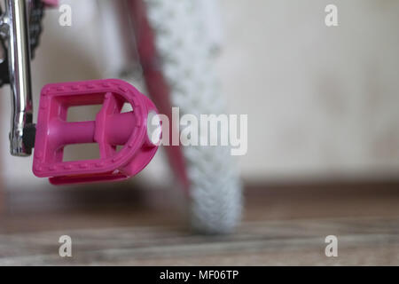 pink child's bicycle closeup with white wheels Stock Photo