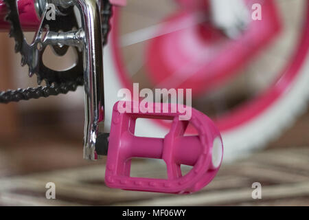 pink child's bicycle closeup with white wheels Stock Photo