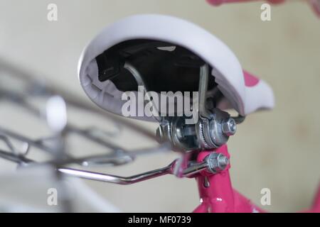 pink child's bicycle closeup with white wheels Stock Photo