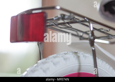 pink child's bicycle closeup with white wheels Stock Photo