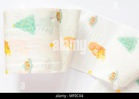 Novelty Christmas toilet paper on roll with Christmas designs set on white background - M&S ultra soft toilet tissue 3-ply Stock Photo