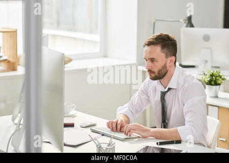 Busy man working hard in office Stock Photo
