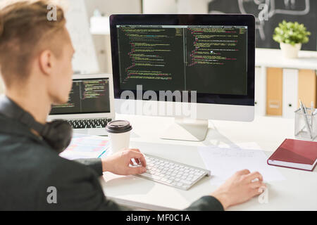 Man coding in office Stock Photo