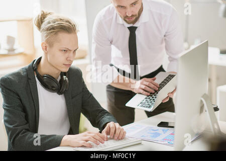 Modern financial analysts using devices for expertise Stock Photo